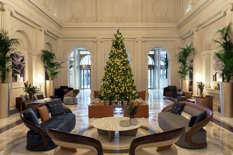 The Christmas tree and lobby display will celebrate the theme of travel in a first-of-its-kind collaboration